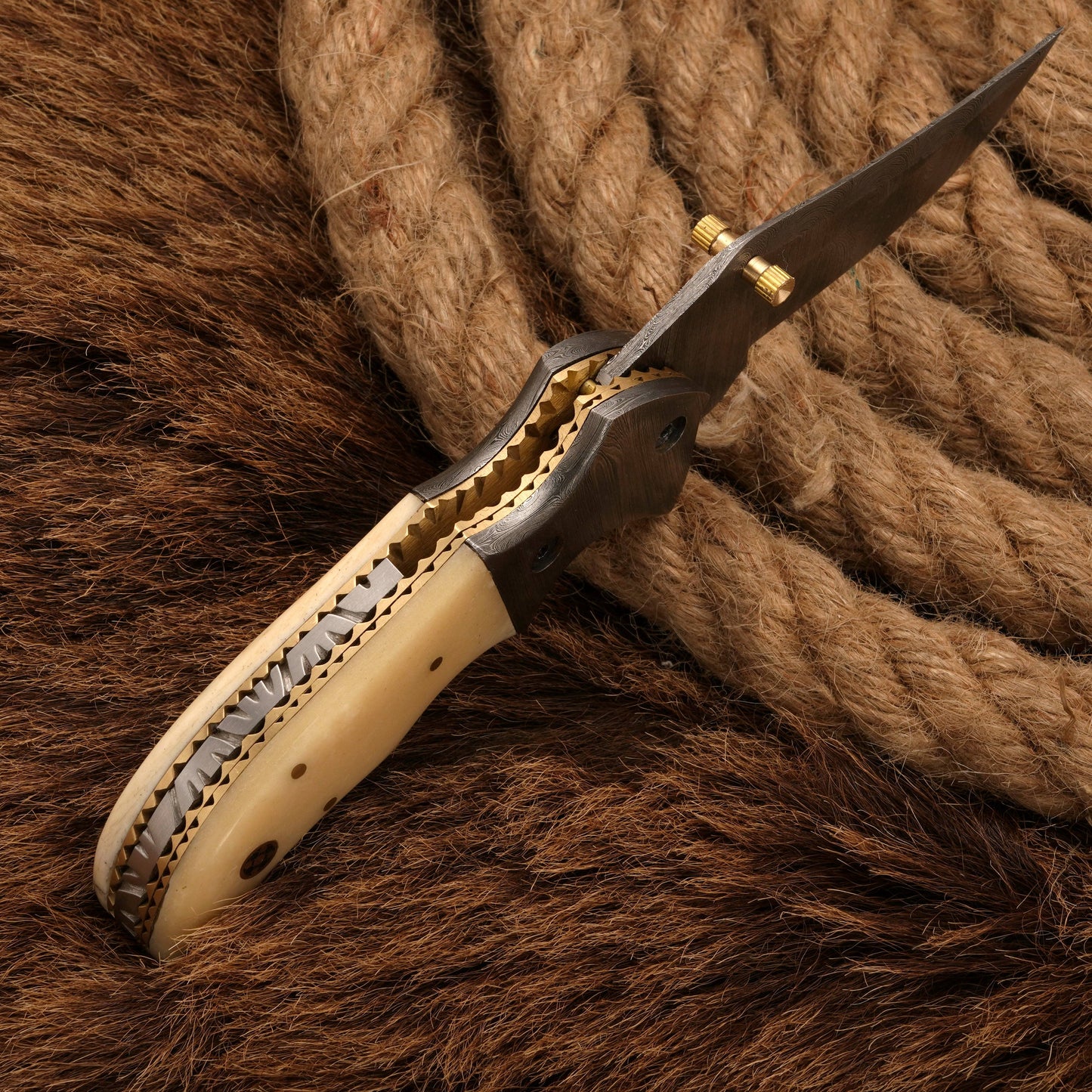 Side view of a Damascus pocket knife with a bone handle, highlighting the intricate spine detailing and folding mechanism.